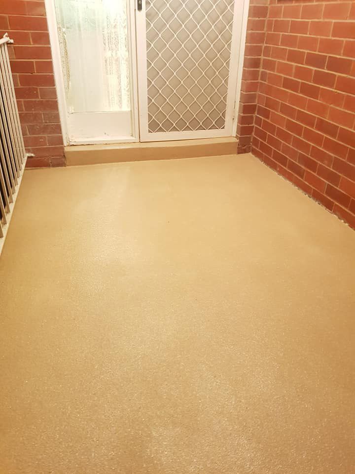 A Room With A Brick Wall And A Sliding Glass Door — Custom Concrete Finishes In Thurgoona, NSW