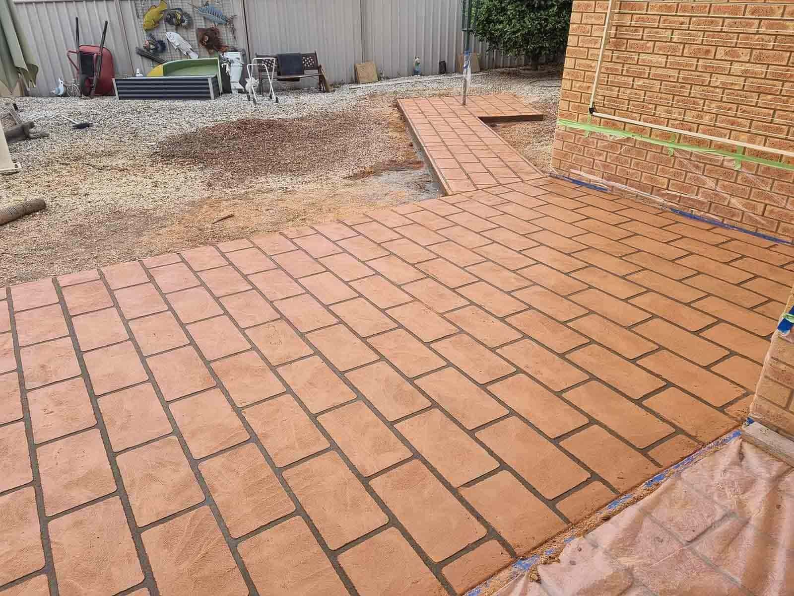 A Brick Pavement Is Being Painted In A Brick Pattern — Custom Concrete Finishes In Thurgoona, NSW
