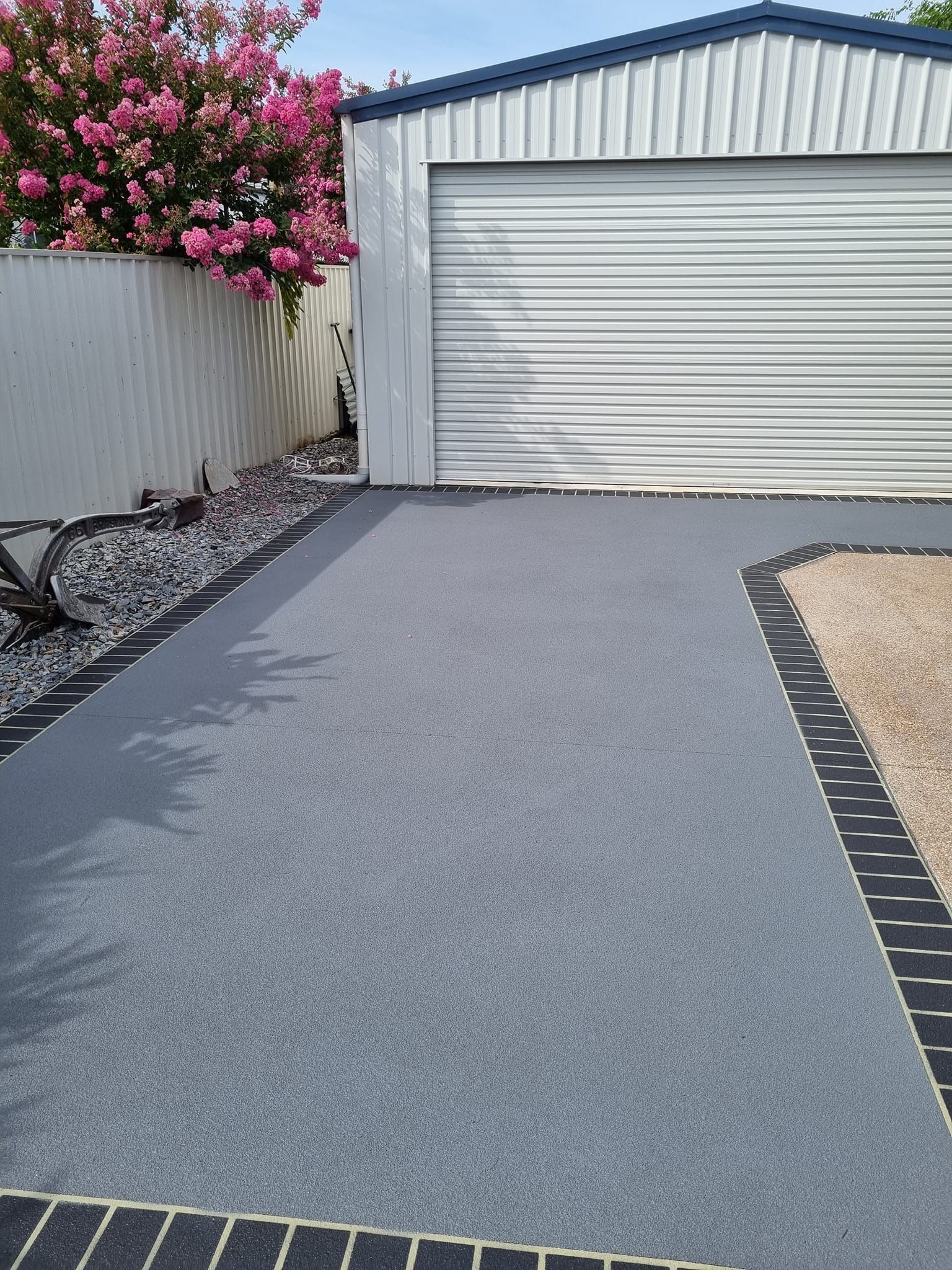 An Aerial View Of A Brick House With A Concrete Driveway Leading To It — Custom Concrete Finishes In Thurgoona, NSW