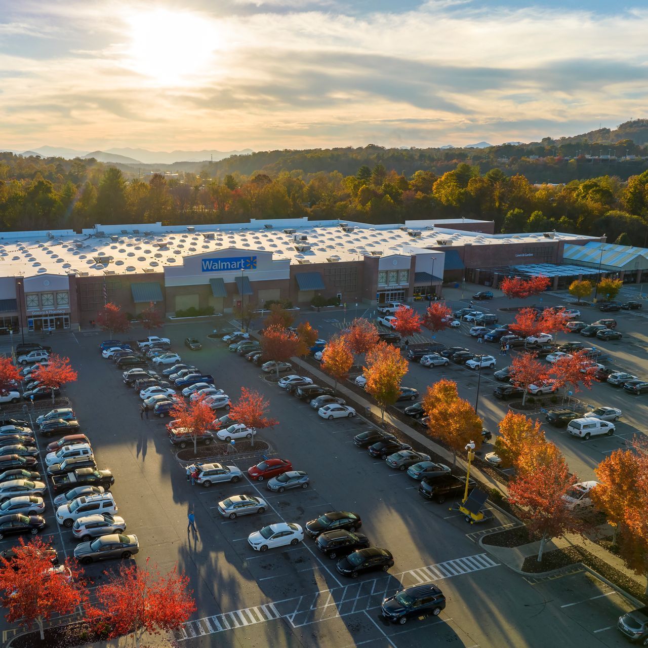 Image of a full Walmart parking lot at sunset.