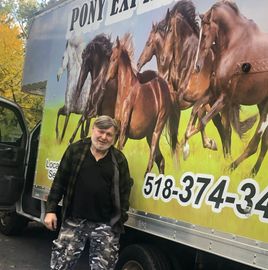 A man standing in front of a pony express truck — Pony Express Moving Co — Niskayuna, NY