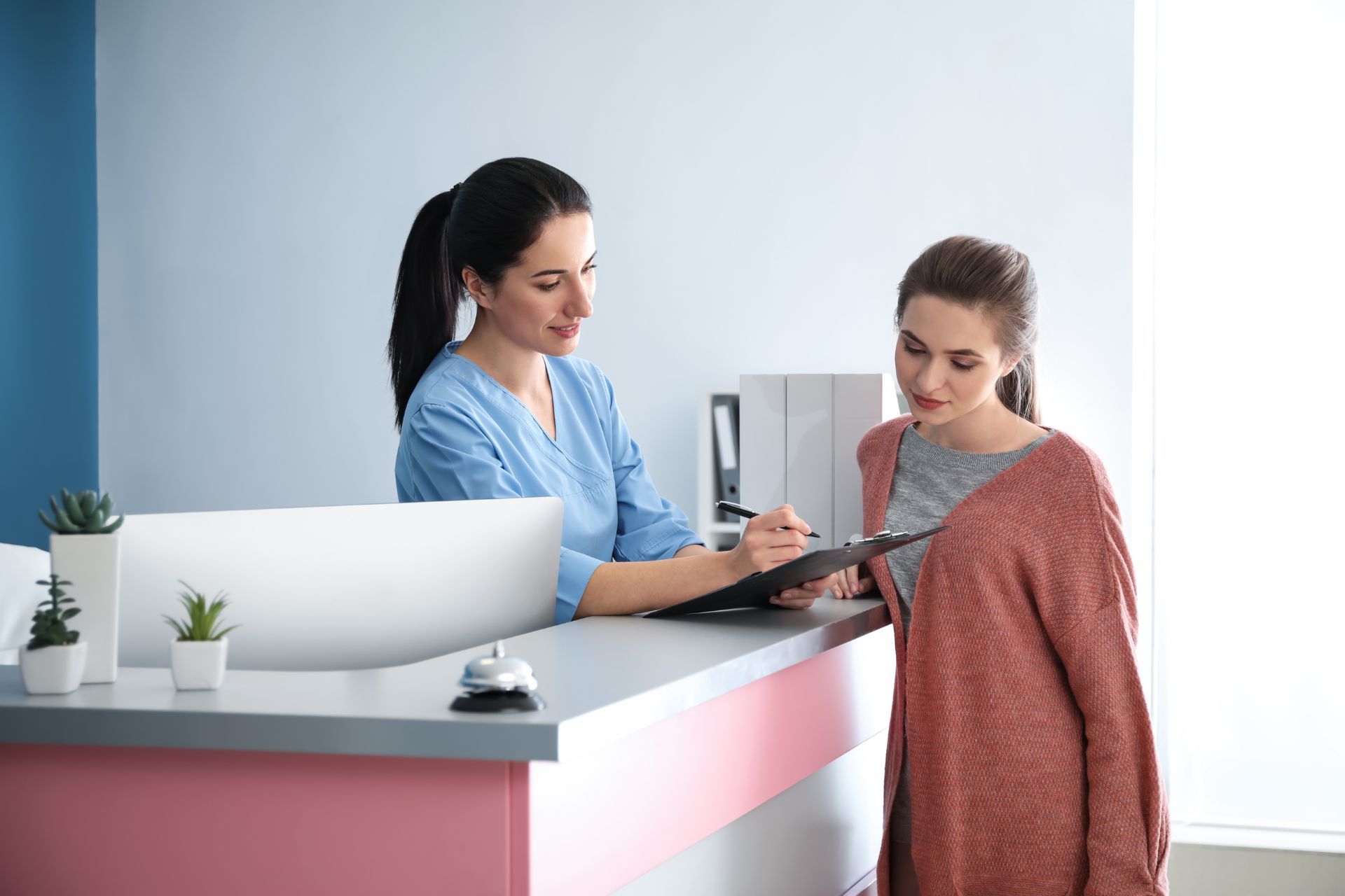 Young woman checking into doctors office