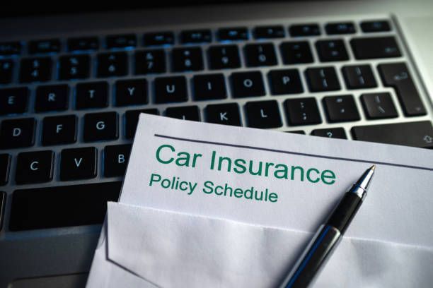 Close-up of a car insurance schedule document from a local auto insurance agency.
