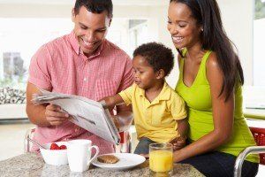 Family Having Breakfast In Kitchen Together