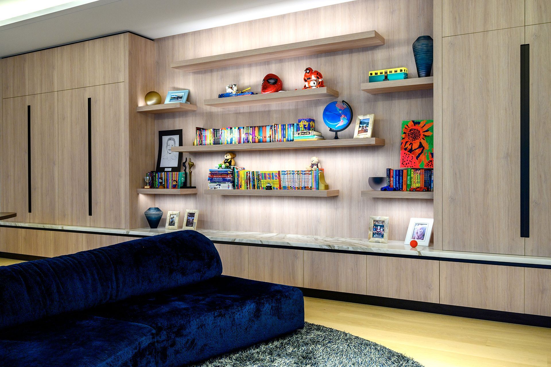 Living Room with Blue Couch & Shelves — Labrador, QLD — Prestige Kitchens