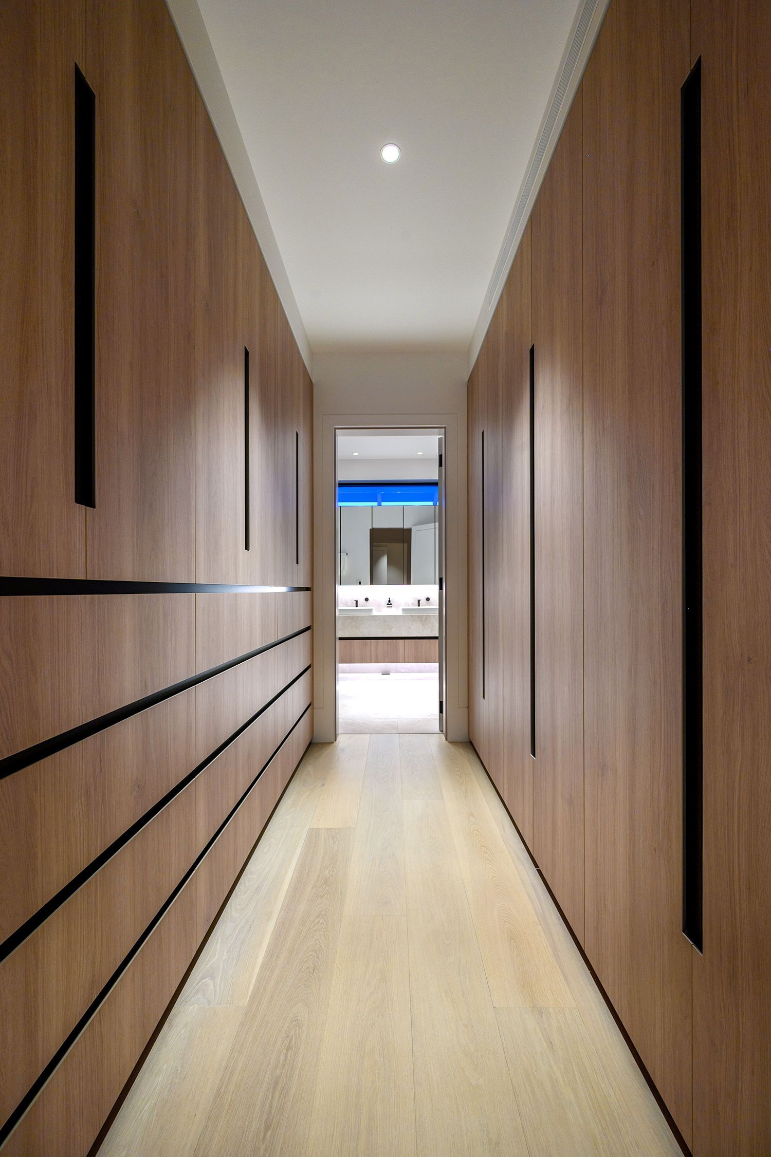Hallway with Wooden Drawers Leading to Bathroom — Labrador, QLD — Prestige Kitchens