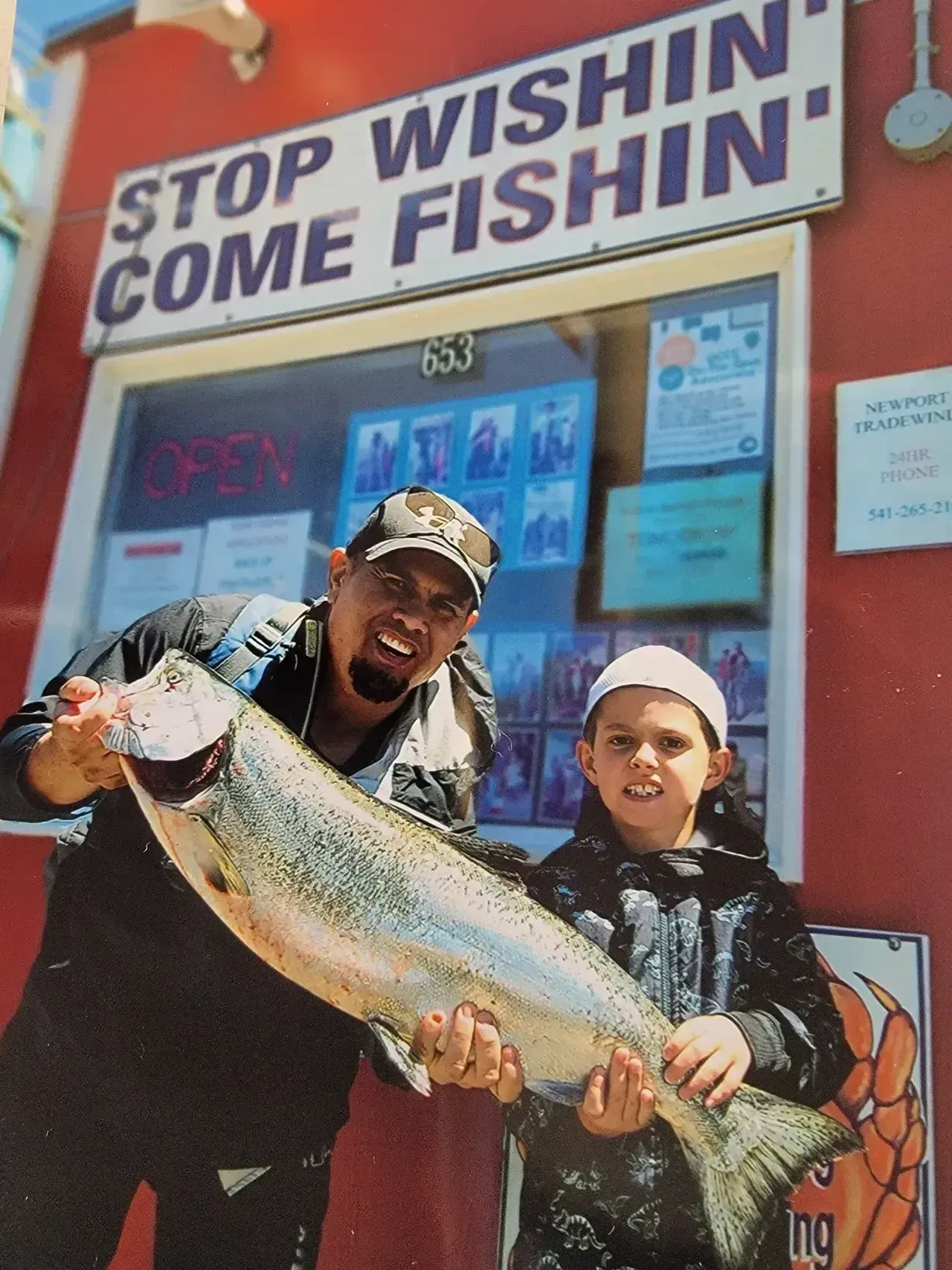 Father and Son Holding a Large Fish