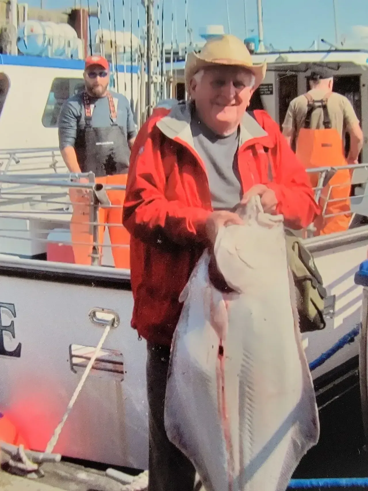 Happy Senior Man Holding a Large Fish