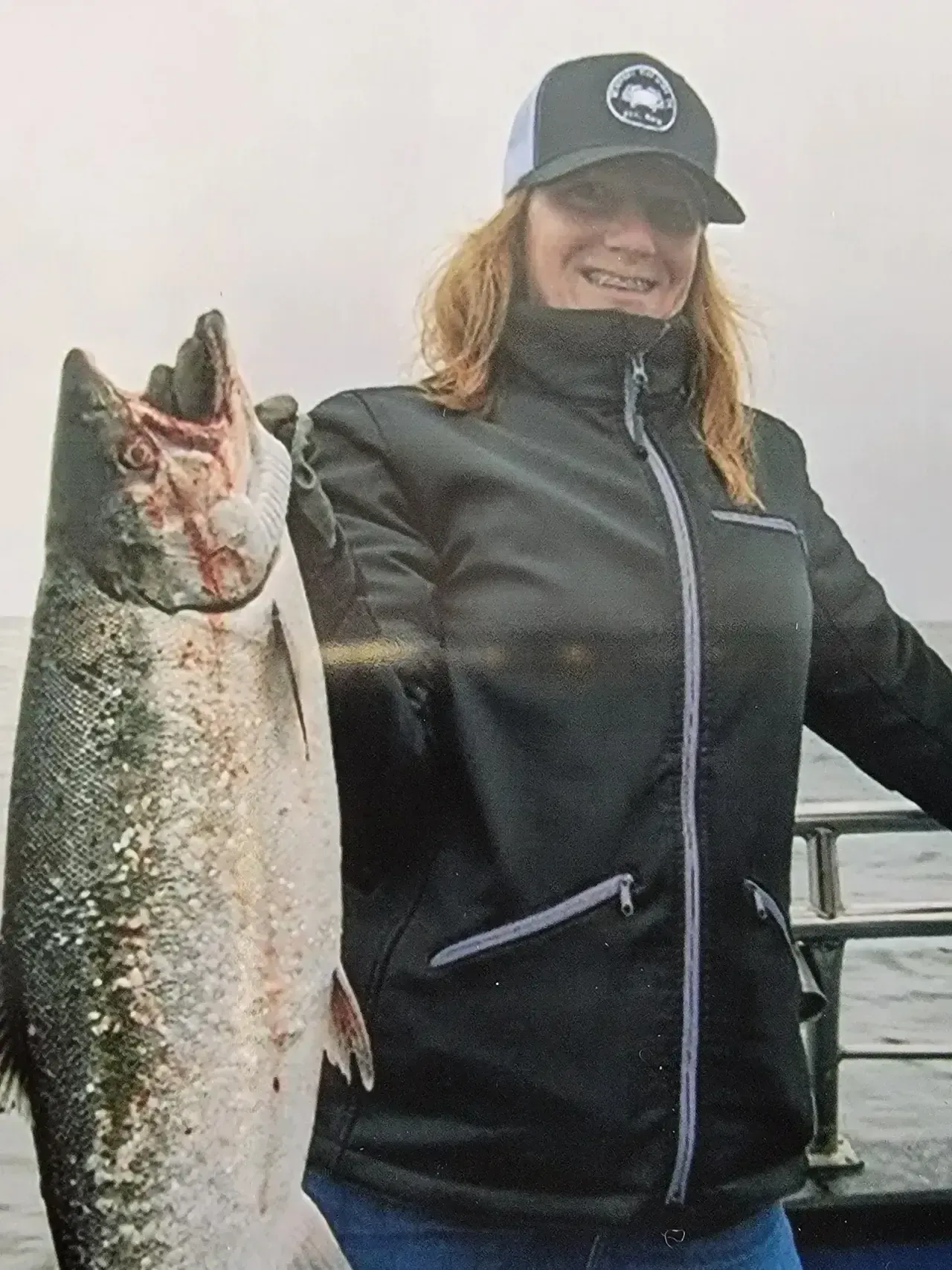 Happy Woman Holding a Large Fish