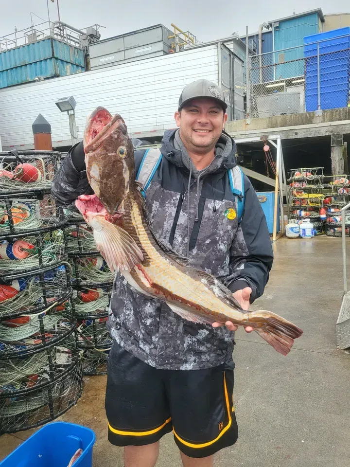 Smiling Man Holding a Large Fish