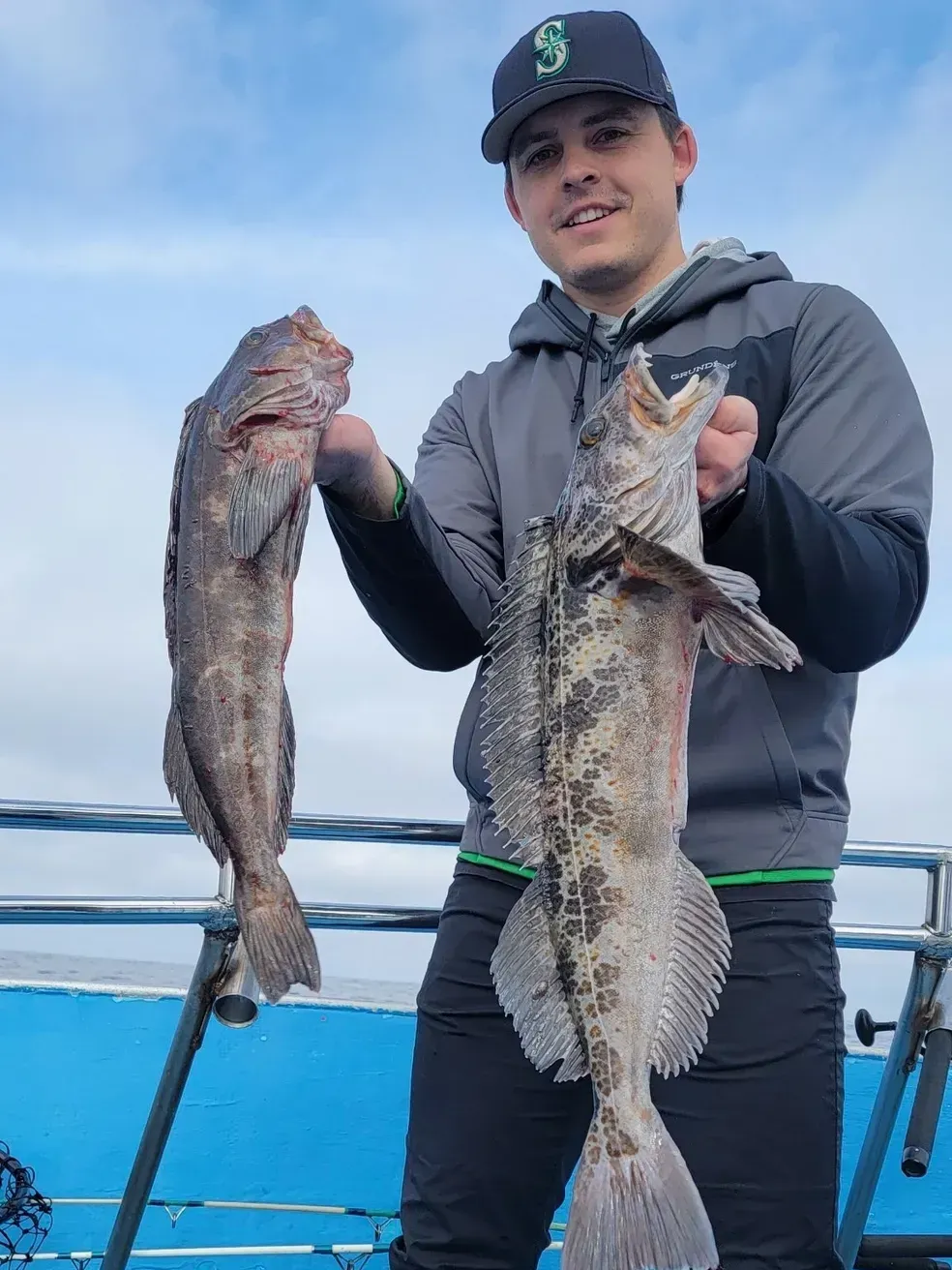 Group of People Standing Around a Pile of Fish