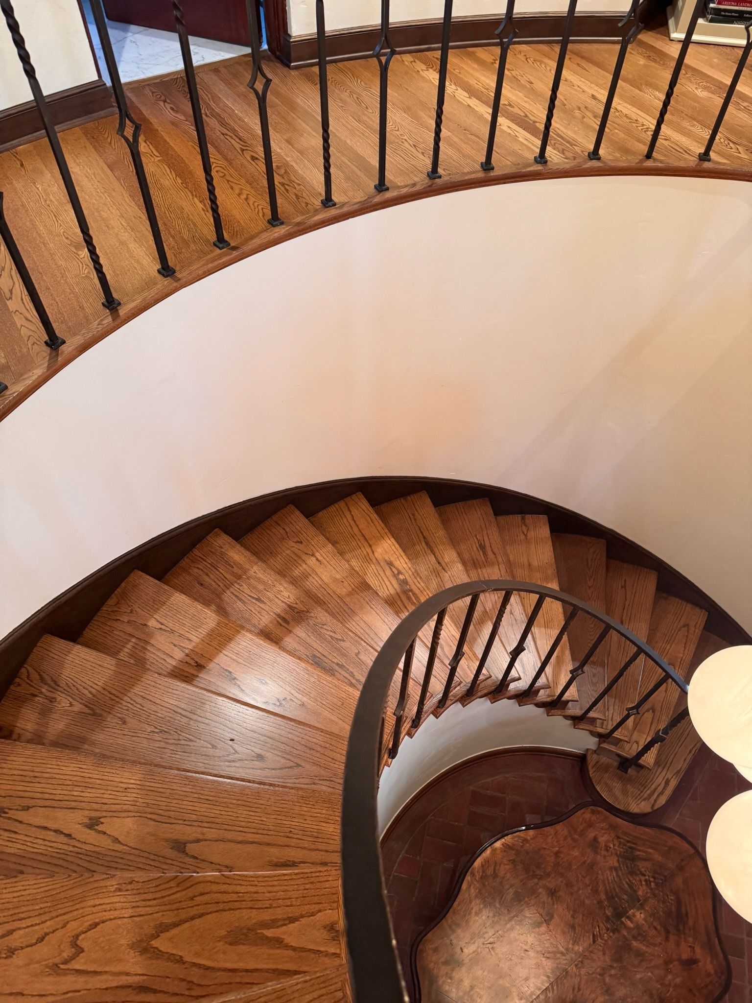 A still life of amber-colored glassware and a clear glass bottle on a white surface, illuminated by soft sunlight.