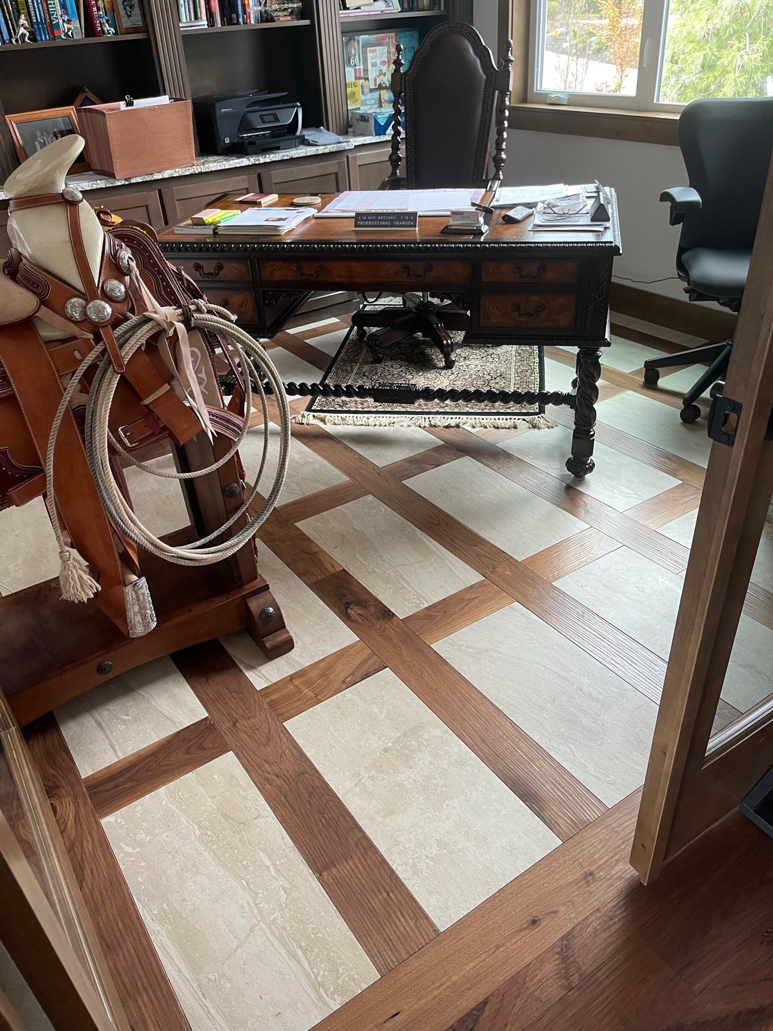 A wooden mid-century modern sideboard sits below a small display shelf and mirror, illuminated by a textured table lamp.