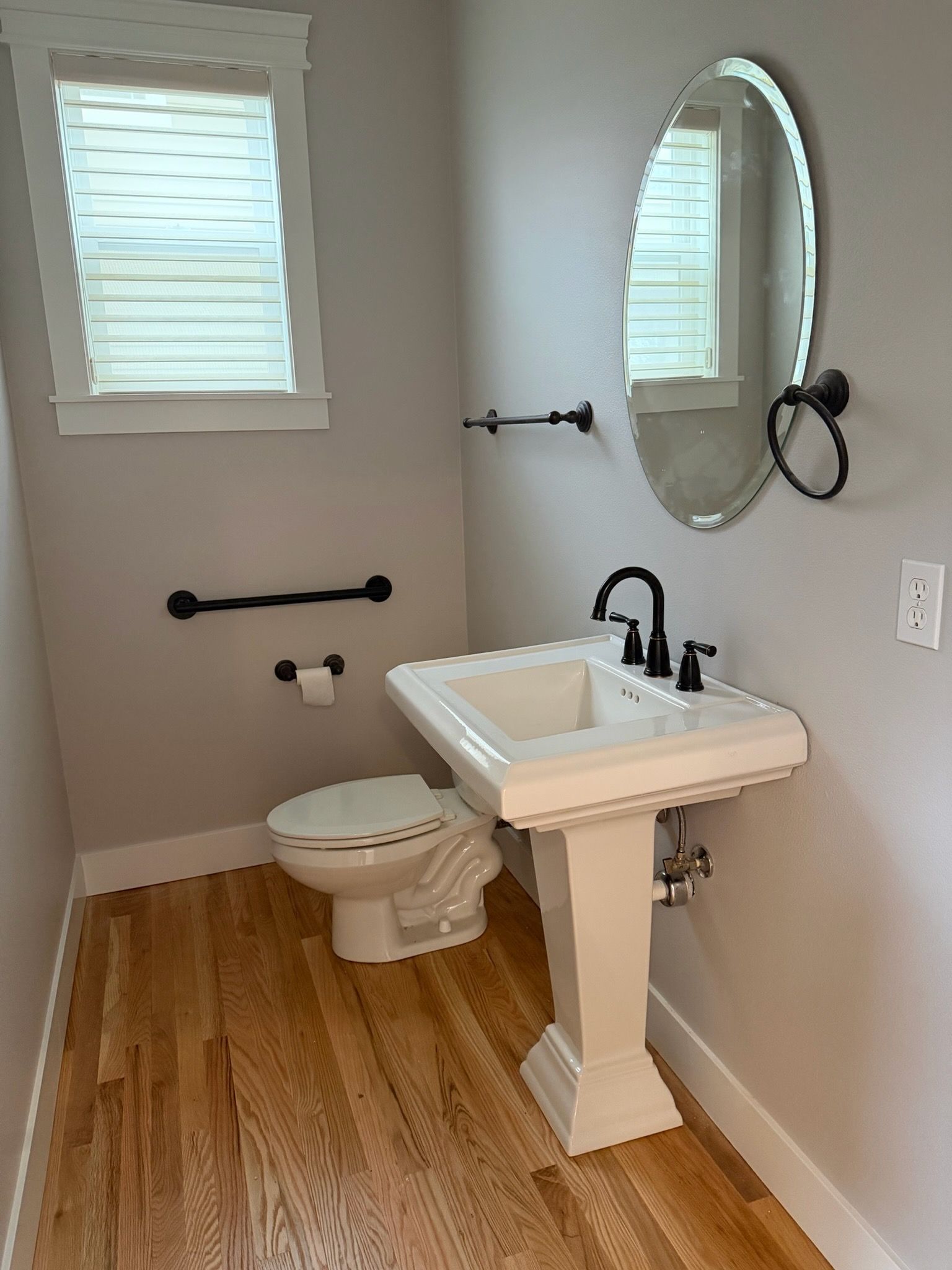 A low-angle view of towering, wave-like orange sandstone walls in a slot canyon, framing a patch of bright sky.