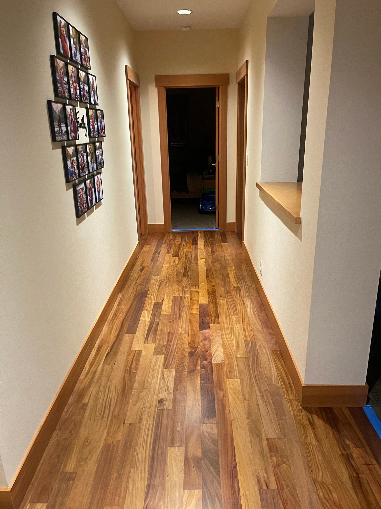 Low-angle view of red brick historic buildings featuring dark-framed lattice windows and peaked dormers against a blue sky.
