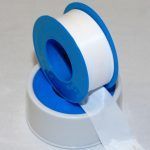 A Roll Of Teflon Tape Is Sitting On Top Of A White Surface — Kirkland, WA — RJB Wholesale Inc.