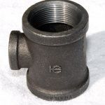 A close up of a black pipe fitting on a white surface.