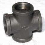 A close up of a black pipe fitting on a white surface.