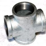 A close up of a metal pipe fitting on a white surface.