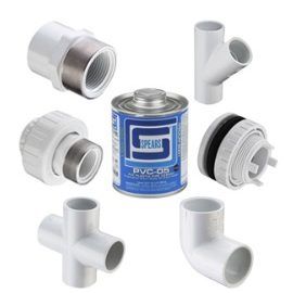 A can of pvc adhesive is surrounded by various pvc pipes and fittings.