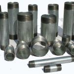 A bunch of metal pipes are sitting on top of each other on a white surface.