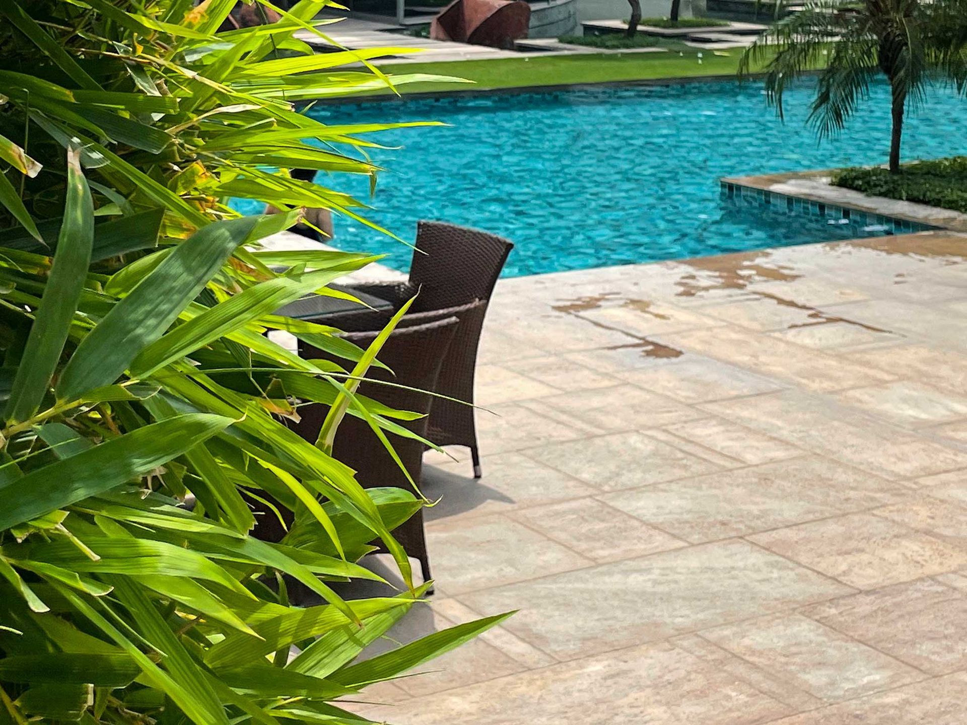 A swimming pool with a table and chairs next to it