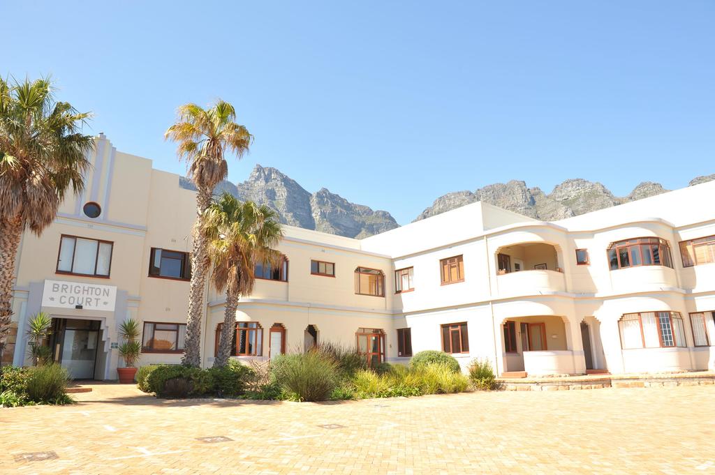 A large white building with palm trees in front of it
