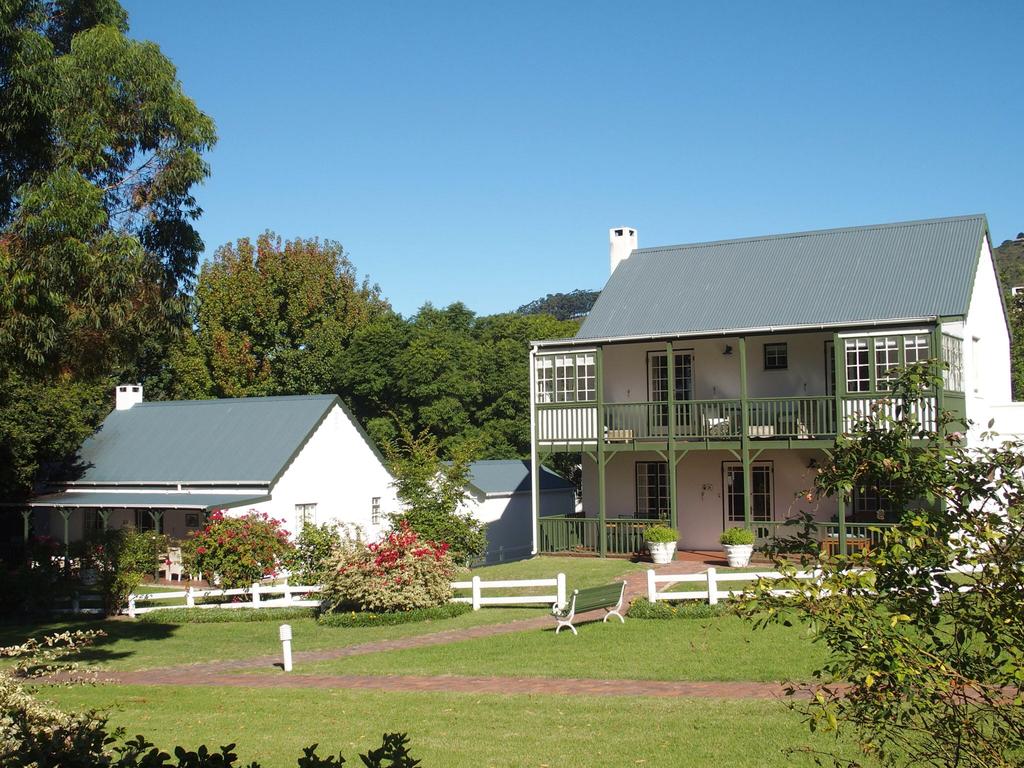 A large white house with a fence in front of it
