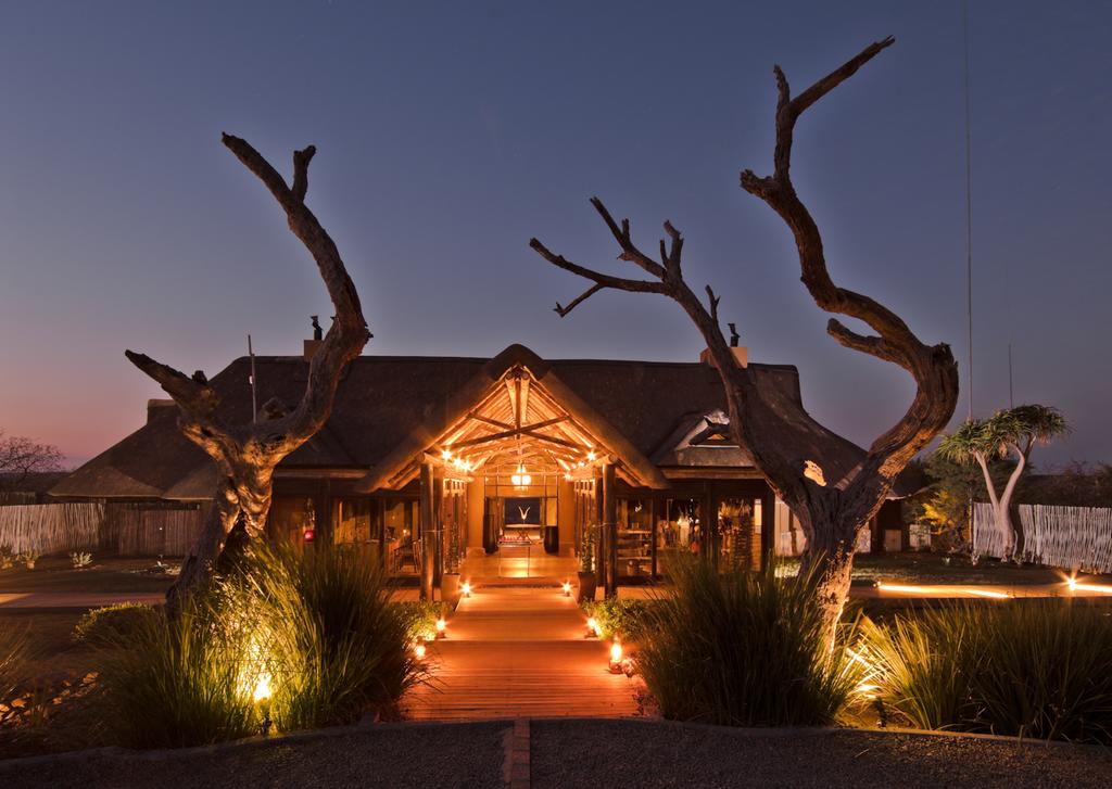 A large house with trees in front of it at night