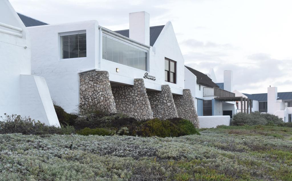 A row of white houses sitting on top of a hill