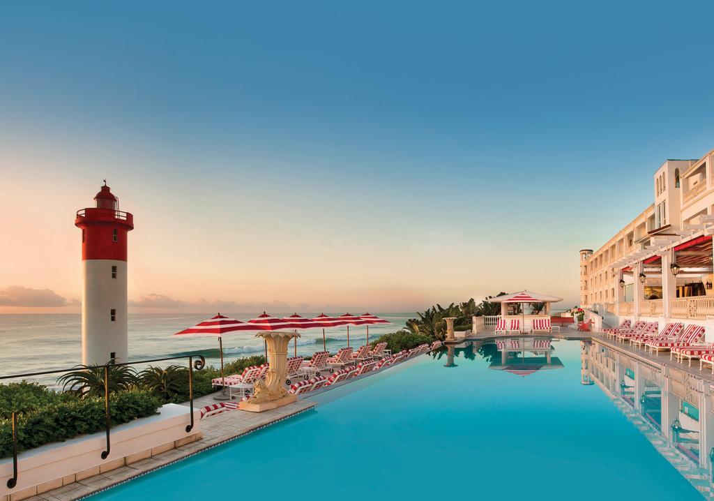 A large swimming pool with a lighthouse in the background