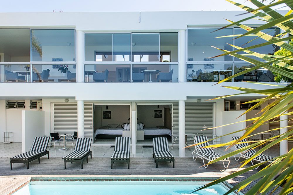 A large building with stairs leading up to it and flowers in front of it.