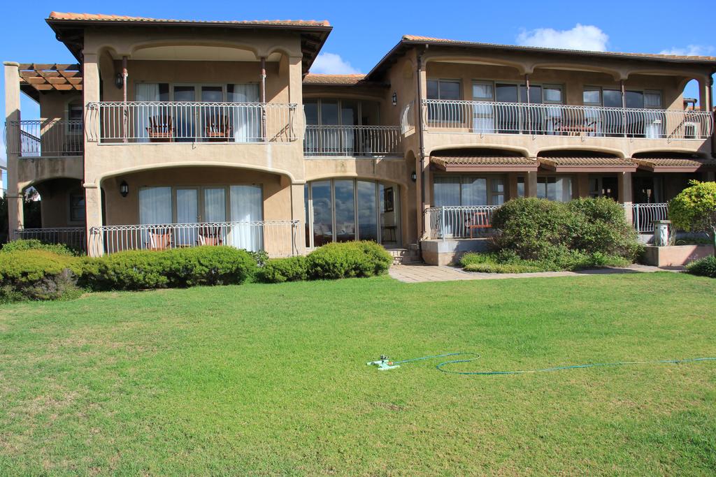 A large house with a large lawn in front of it.