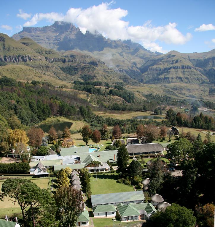 An aerial view of a village with mountains in the background