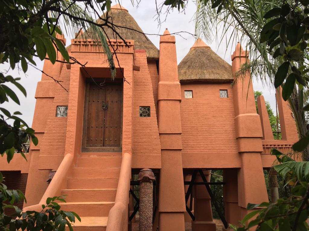A brick building with a thatched roof and stairs