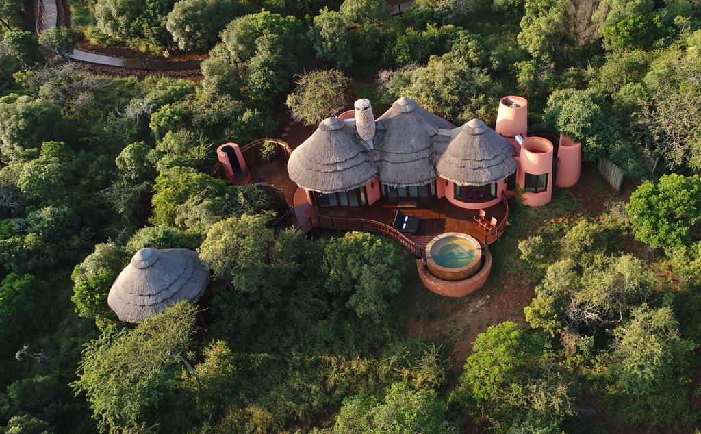 An aerial view of a house in the middle of a forest