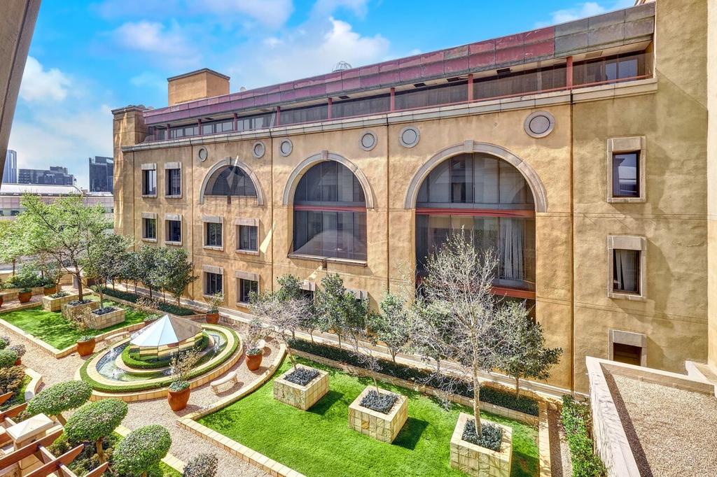 An aerial view of a large building with a garden in front of it.