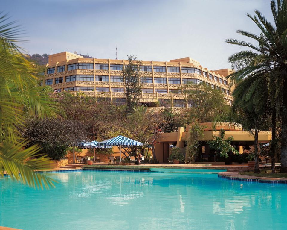 A large building with a swimming pool in front of it