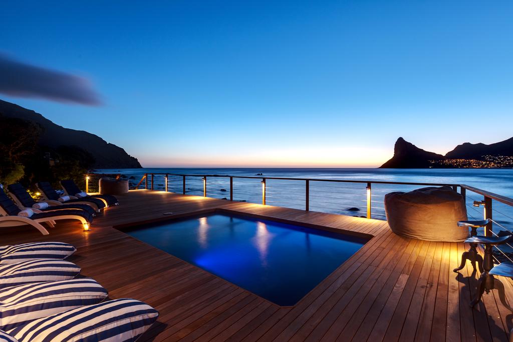 A large swimming pool on a deck overlooking the ocean