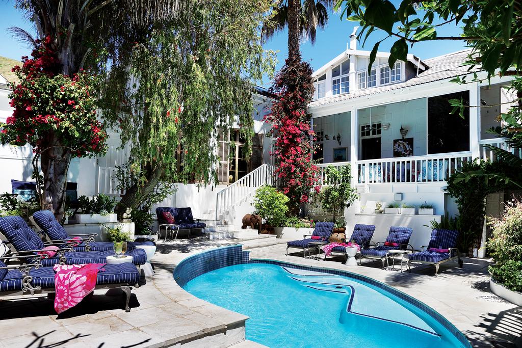 A large white house with a swimming pool in front of it