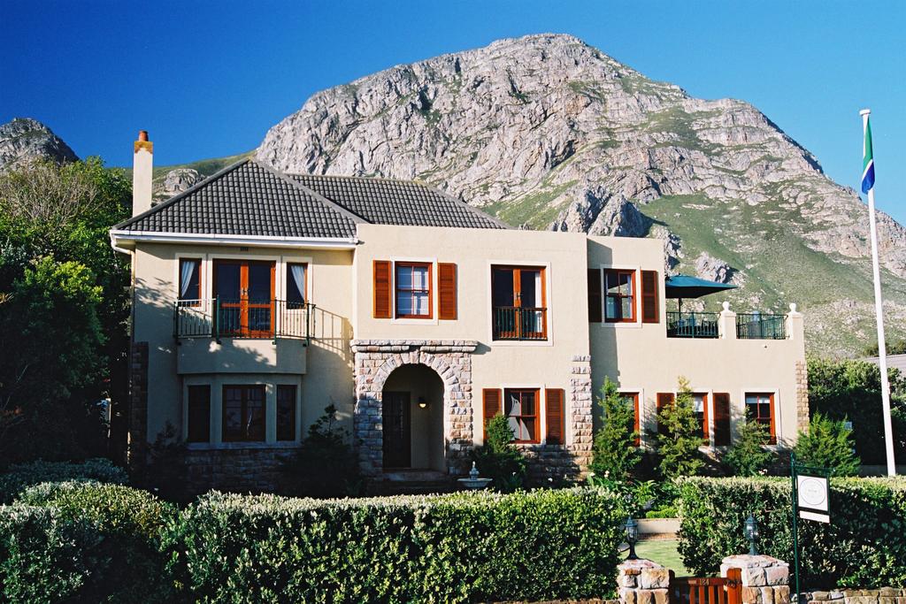 A large house with a mountain in the background