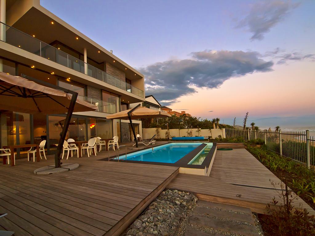 A large house with a swimming pool in front of it