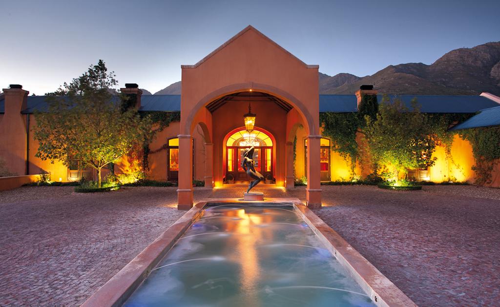 A large house with a pool in front of it
