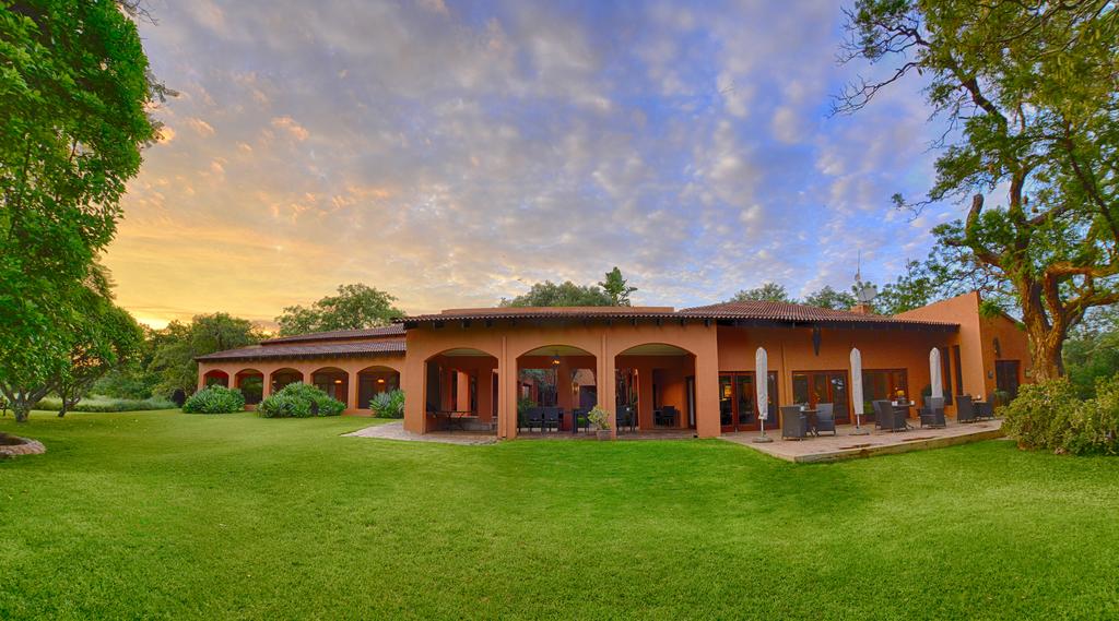 A large house with a large lawn in front of it.