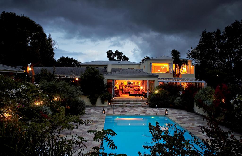 A large house with a swimming pool in front of it