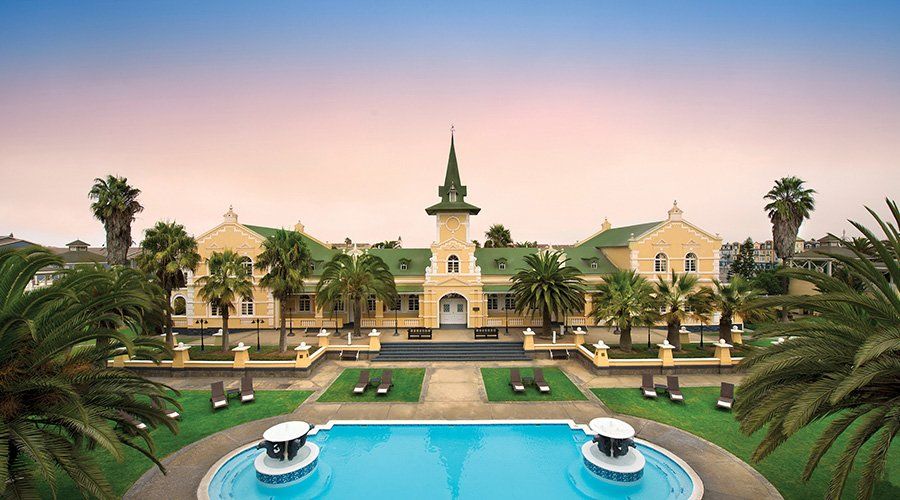 A large building with a swimming pool in front of it