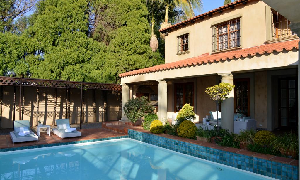 A large house with a swimming pool in front of it