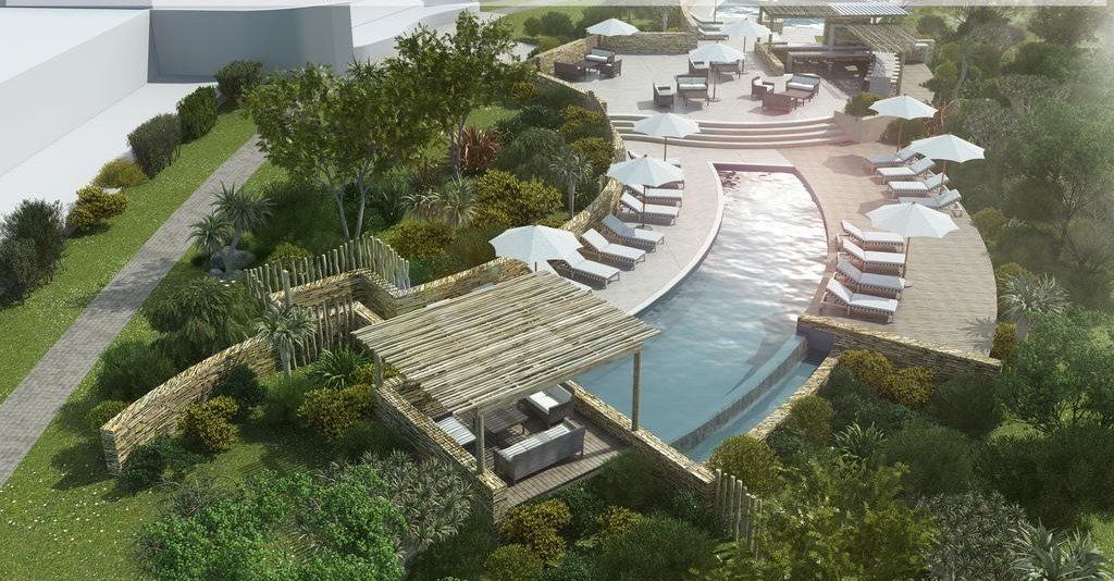 An aerial view of a swimming pool surrounded by trees