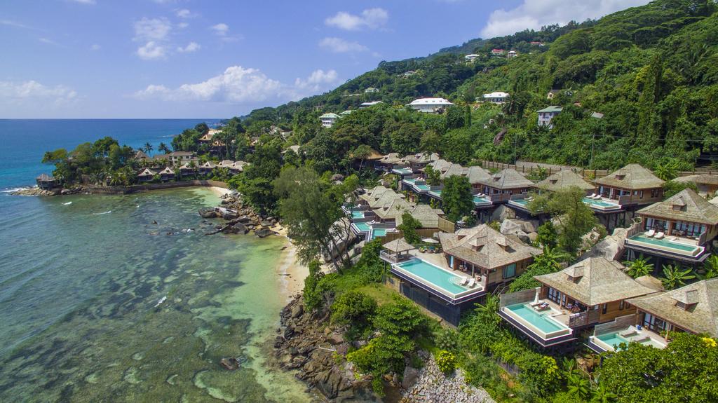 An aerial view of a resort on a cliff overlooking the ocean.