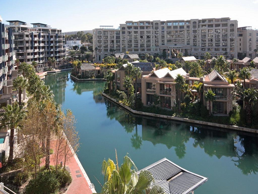 A large body of water surrounded by buildings and palm trees
